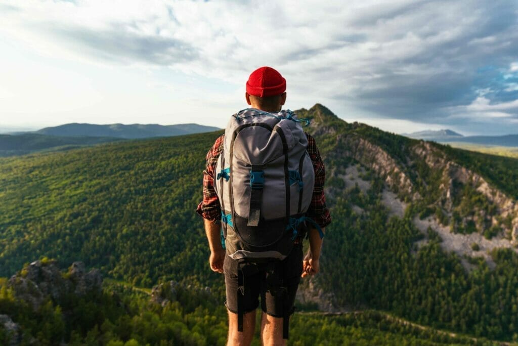 a tourist with a backpack is standing on the top o 2022 01 21 20 44 14 utc