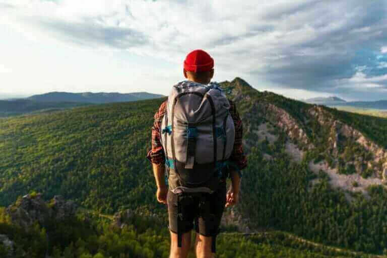 a tourist with a backpack is standing on the top o 2022 01 21 20 44 14 utc