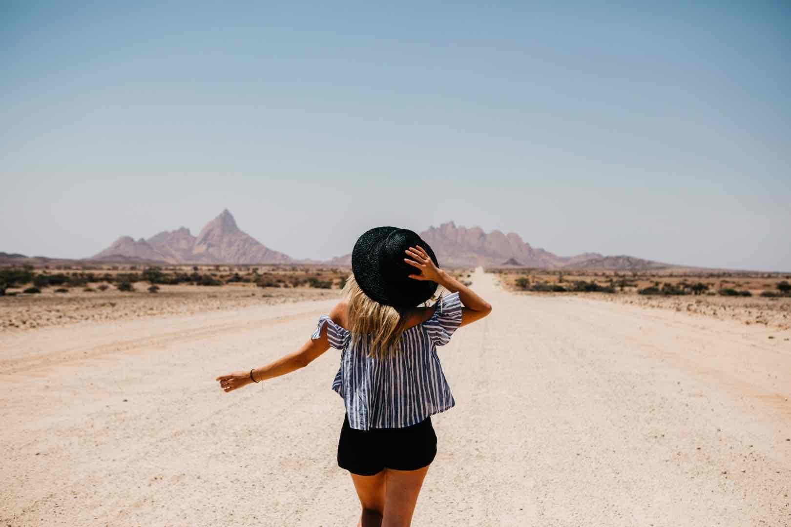 namibia woman walking on the road to spitzkoppe 2022 12 16 22 26 37 utc