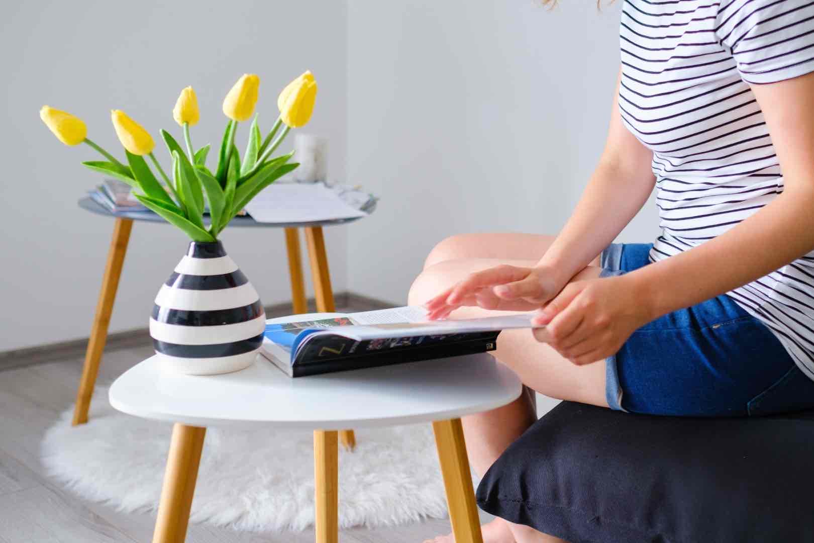 young woman reading a catalog or travel magazine a 2021 10 18 17 54 23 utc