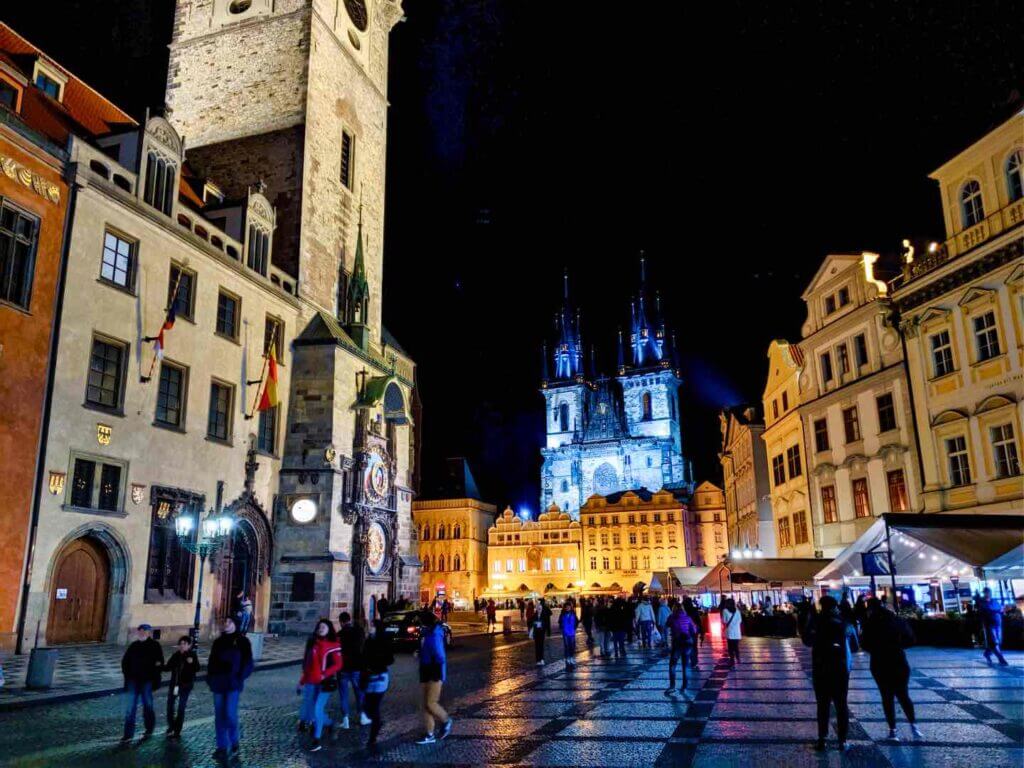 Prague Main sqaure at night with clock on the left